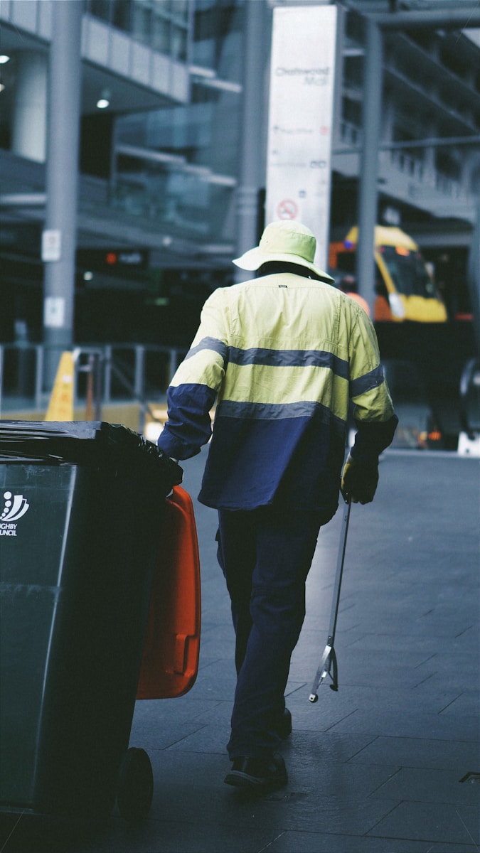 a man walking down a street with a suitcase