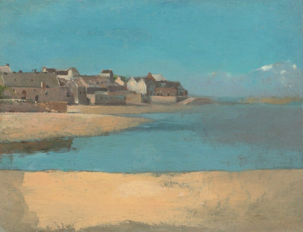 Coastal town with buildings on a hill overlooking water